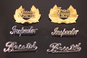 A selection of Bristol Omnibus Inspector,Senior Inspector and normal Bristol scroll badges.